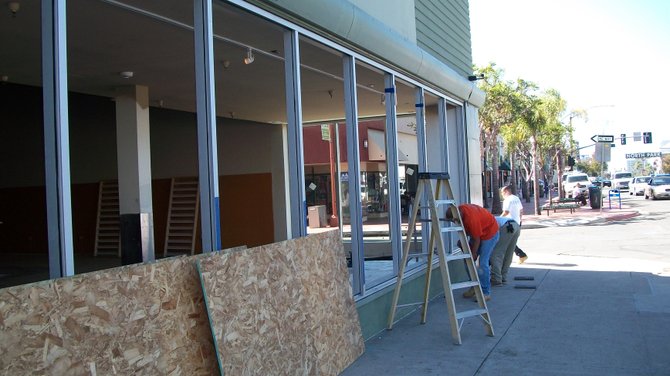 Workmen install windows at the new Wang's North Park restaurant, at 3029 University Avenue.