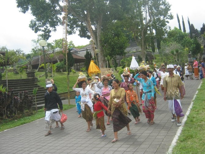 Locals carry baskets of offerings to the Besakih Temple, the most sacred temple in Bali.