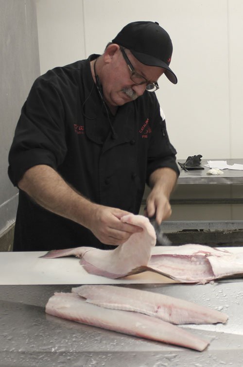 Tommy Gomes from Catalina Offshore, the organizer of Collaboration Kitchen, butchering a halibut onsite before marinating it and offering it up during the session