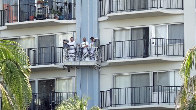 Painters at a high-rise senior apartment building in North Park.