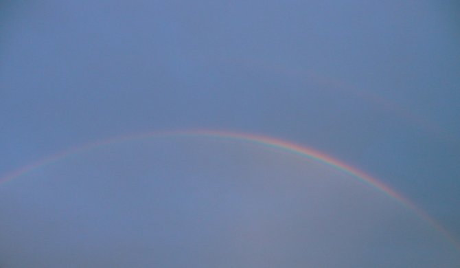 Rainbow showing reflections inside and outside itself over North Park.