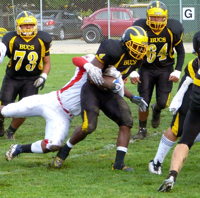 Mission Bay running back Chris Byrd fights through a Hoover tackle attempt
