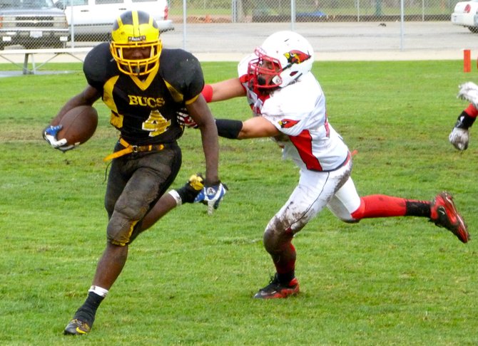 Mission Bay running back Chris Byrd runs outside with Hoover defensive lineman Eddie Clark latched on