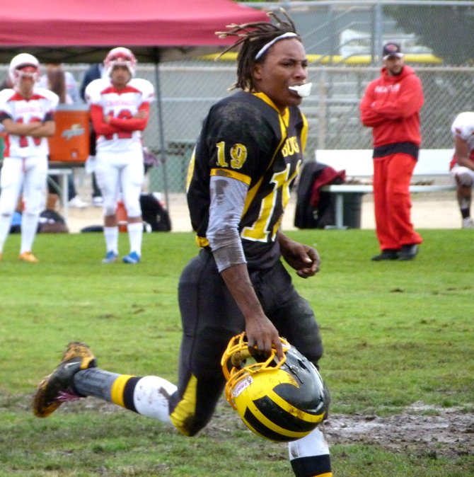 Mission Bay receiver JaQuan Madyun airs out his hair while jogging off the field
