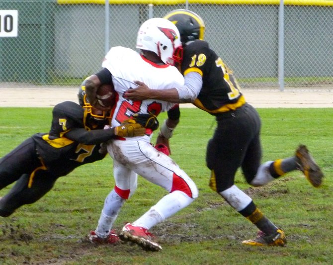 Hoover receiver Arthur Wilson wrapped up by Mission Bay linebacker Joseph Griffin (left) and defensive back JaQuan Madyun
