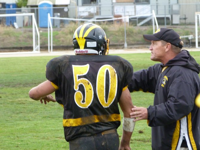 Mission Bay head coach Willie Matson directs Buccaneers linebacker Dylan Lieto along the sidelines