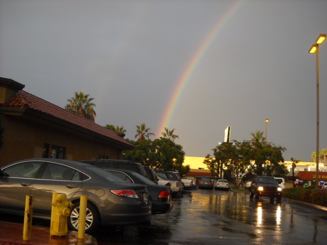 A rainbow among the wet parking lots along Midway Drive.