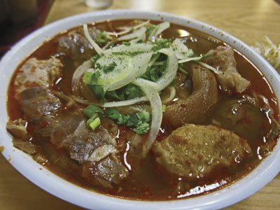 Bun bo hue "dac biet" from Hoai Hue Deli. Beef shank, pork hock, and meatballs are in full view.