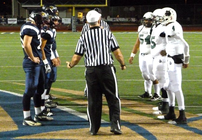 Steele Canyon and Helix team captains meet at midfield for the coin toss