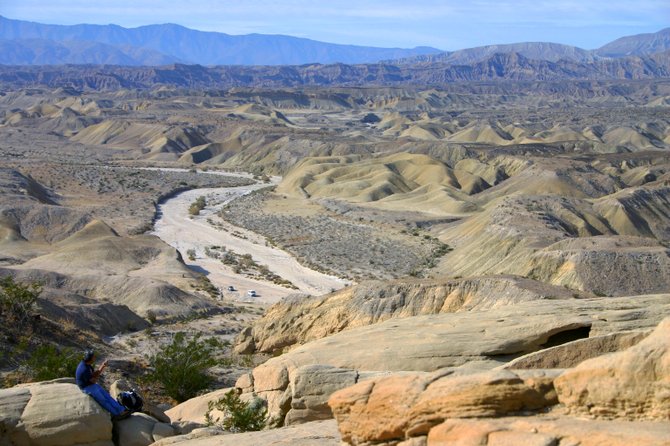 A hiker enjoys lunch while taking in the views of the Anza Borrego Desert.