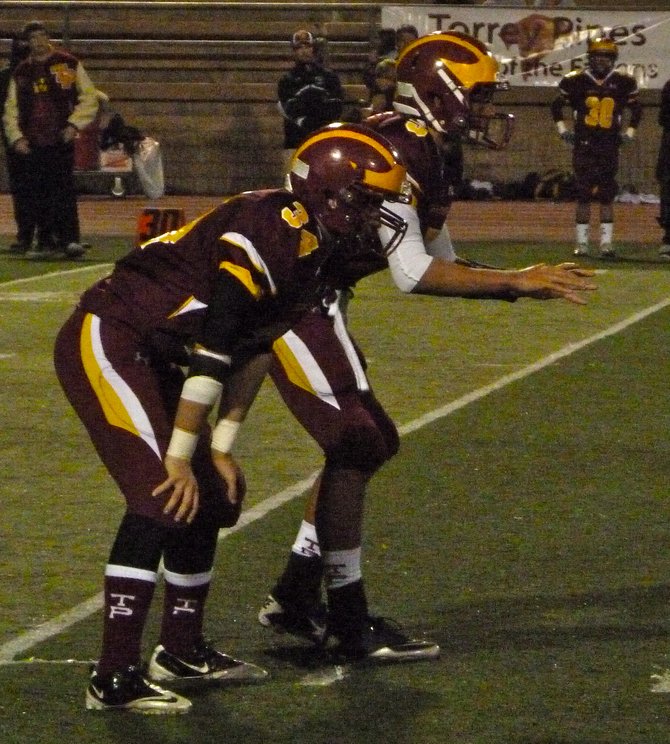 Torrey Pines quarterback Andrew Perkins and running back Aaron Small (34) in the offensive backfield