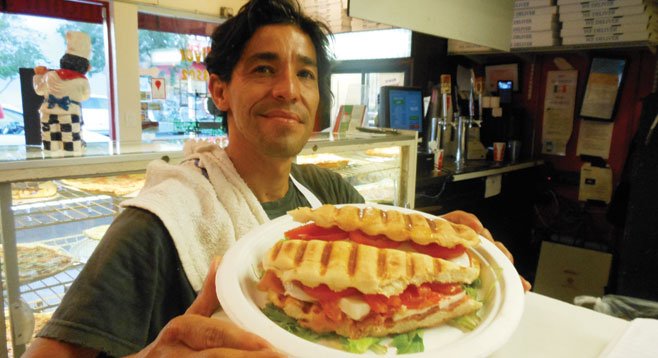 Carlos serves up a Fiorentini panini — prosciutto, mozzarella, tomatoes, and oregano.