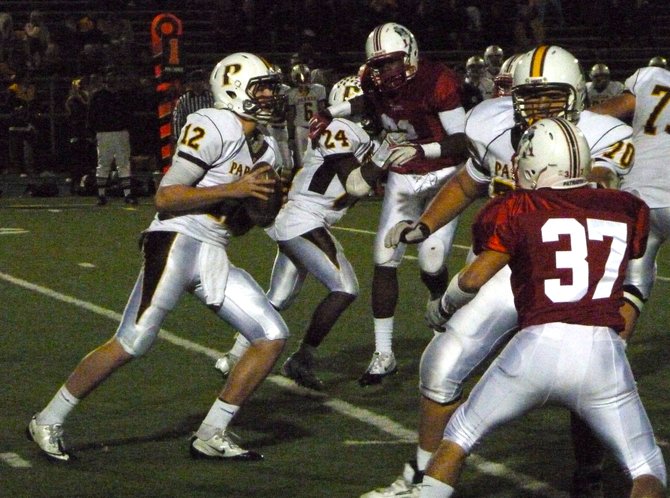 Francis Parker quarterback Gabe Harrington looks for a receiver with a pair of Christian defenders collapsing the pocket