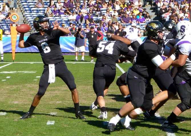 Valley Center quarterback Ryan Kleiman fires a pass from behind a wall of Jaguars' blockers