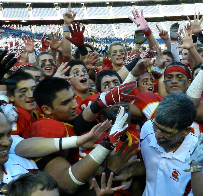 Cathedral Catholic players swarm Dons head coach Sean Doyle as part of the championship celebration
