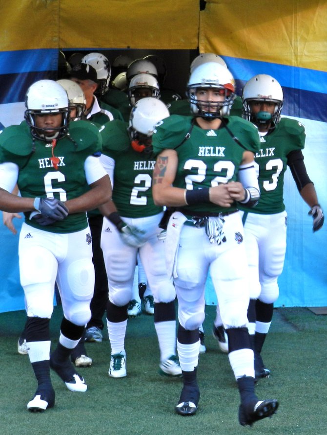 Helix running back Darrion Hancock (6) and Romello Carbuccia (22) lead the Highlanders onto the field before the Division II Finals
