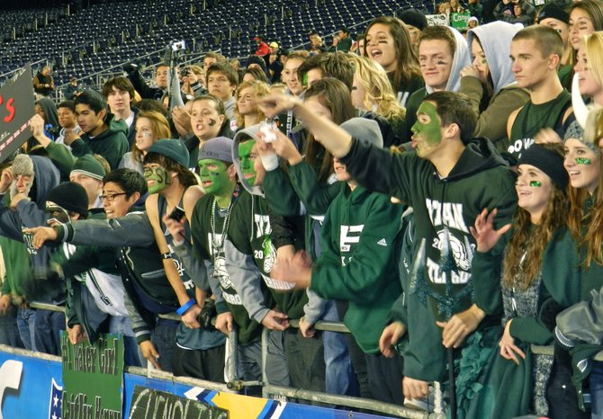Green clad Poway students celebrate the Titans' win over Vista in the Division I finals