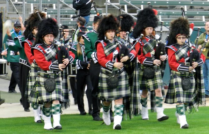 Helix bagpipe players lead the Highlanders onto the field dressed in traditional Scottish garb