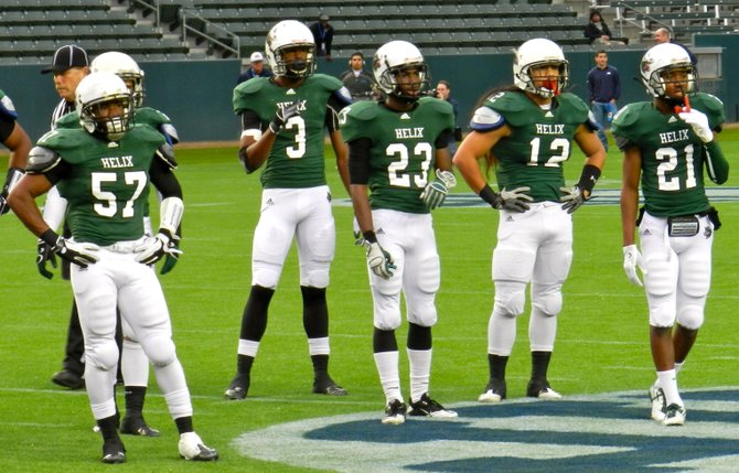 Helix defensive players look to the sideline for the play call