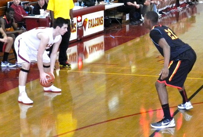 Torrey Pines guard Garrett Galvin guarded on the perimeter by Dominguez forward Arnold Anderson