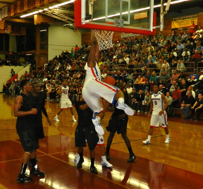 DeMatha forward Beejay Anya throws down a two-handed dunk against Lincoln