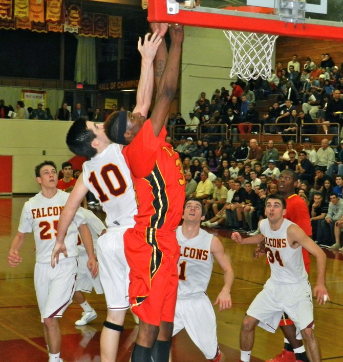 Taft forward Anthony January and Torrey Pines guard Garrett Galvin elevate for a rebound