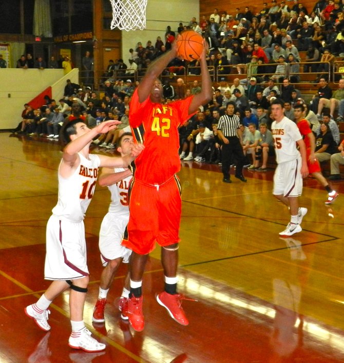 Taft forward Brandon Perry goes up for a shot in front of two Torrey Pines defenders