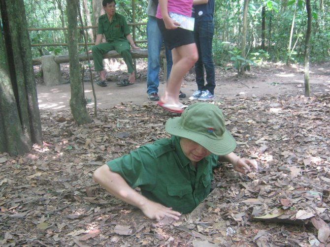 Entering the Cu Chi tunnels, used by the Viet Cong to evade American troops and bombs during the Vietnam War.
