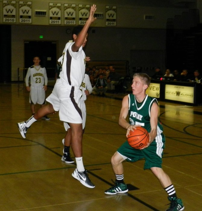 Poway guard Taylor Miller tries to pass around West Torrance guard Jamin Lackey in the lane