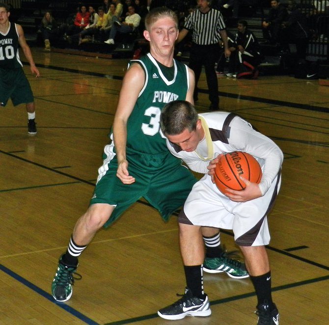 West Torrance guard Nicky Roos shields the ball from Poway guard Taylor Miller