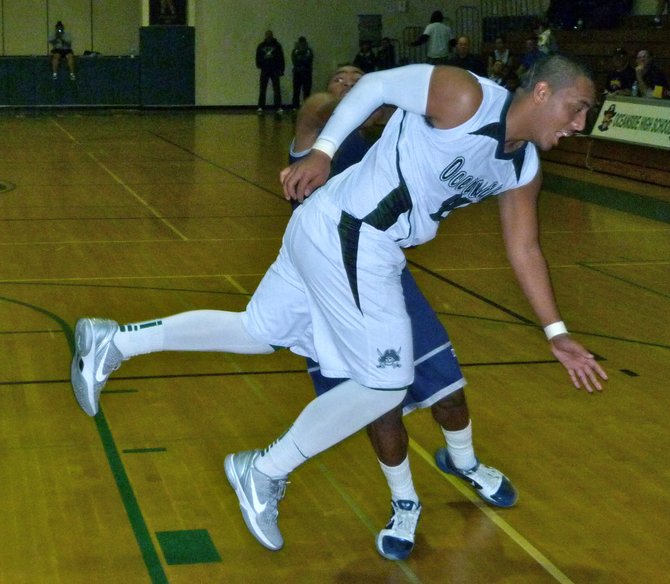 Oceanside guard Tofi Pao Pao goes flying after a shot fake by San Marcos guard M.J. Bailey