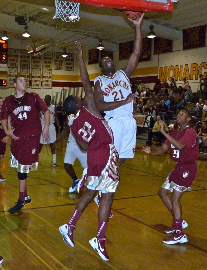 Monte Vista guard Rueben Nwando goes up for a layup in the lane against Mission Hills guard Dolyn Hall