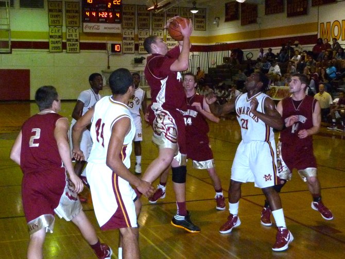 Mission Hills center Kameron Rooks pulls down a rebound in a crowded lane