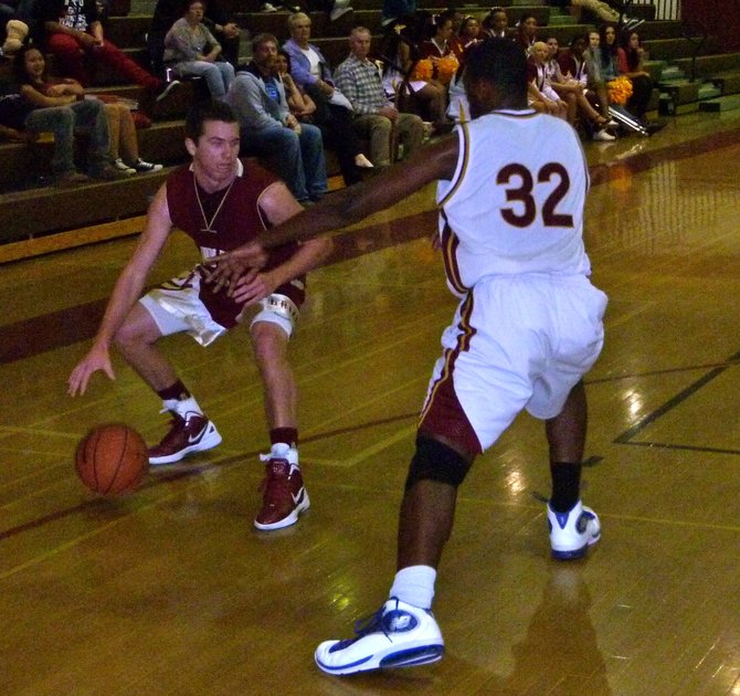 Mission Hills guard Nate Delaney guarded on the perimeter by Monte Vista forward Kylie Luster