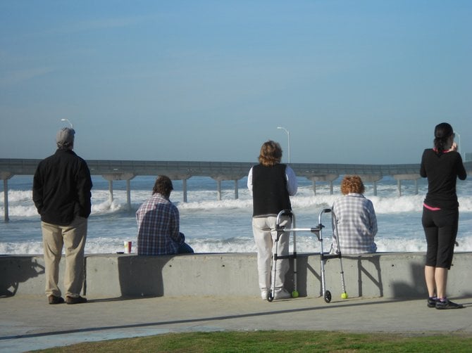 Lots of people watching big wave action near Pier in Ocean Beach.