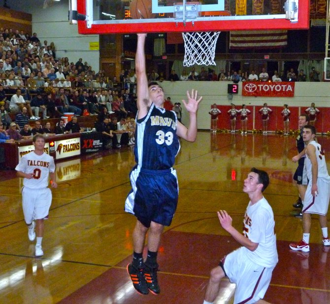 La Costa Canyon guard Zach Beery puts up a layup in front of Torrey Pines guard Sam Worman