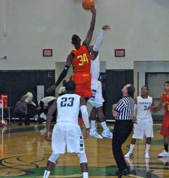 Taft forward Anthony January wins the tip against Lincoln guard Tyrell Robinson