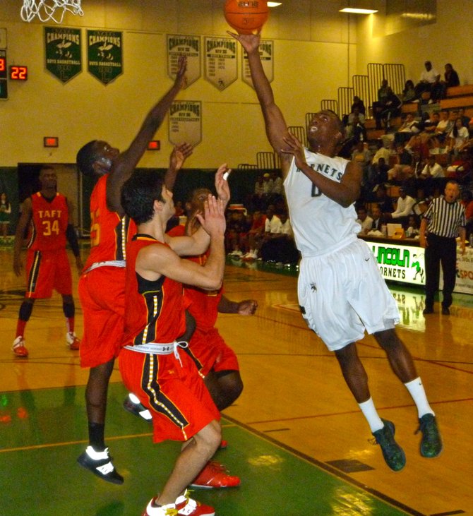 Lincoln guard Tyrell Robinson elevates for a shot in front of three Taft defenders