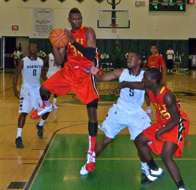 Taft forward Anthony January pulls down a rebound in the paint against Lincoln