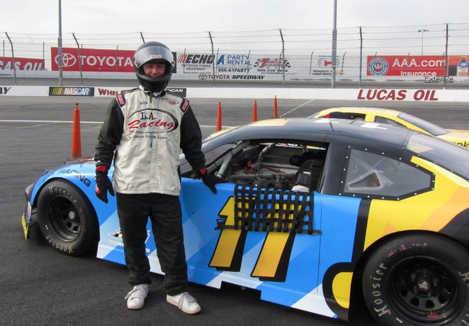 A driver ready to take his car out for 20 laps at the Toyota Motor Speedway in Irwindale, CA.  