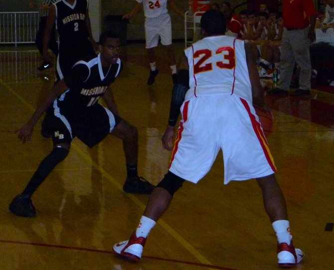Mission Bay forward James Cloud defends Cathedral Catholic forward Xavier Williams in the backcourt