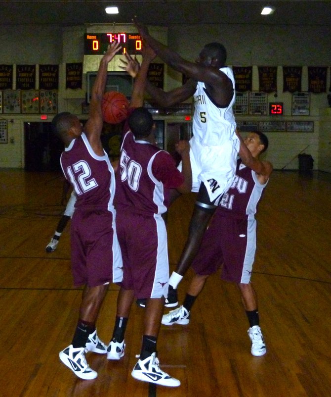 Army-Navy center Cheikh N'Diaye loses the ball in the lane between three Rancho Buena Vista defenders
