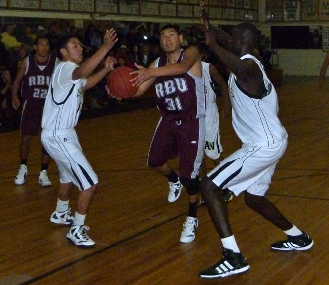 Rancho Buena Vista guard Fabian Hernandez goes up for a shot in the lane between three Army-Navy defenders