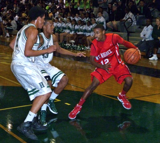 Mount Miguel guard Marcus Booker steps back to try and shake Helix forwards Derrick Chandler (right) and Isaac Randall