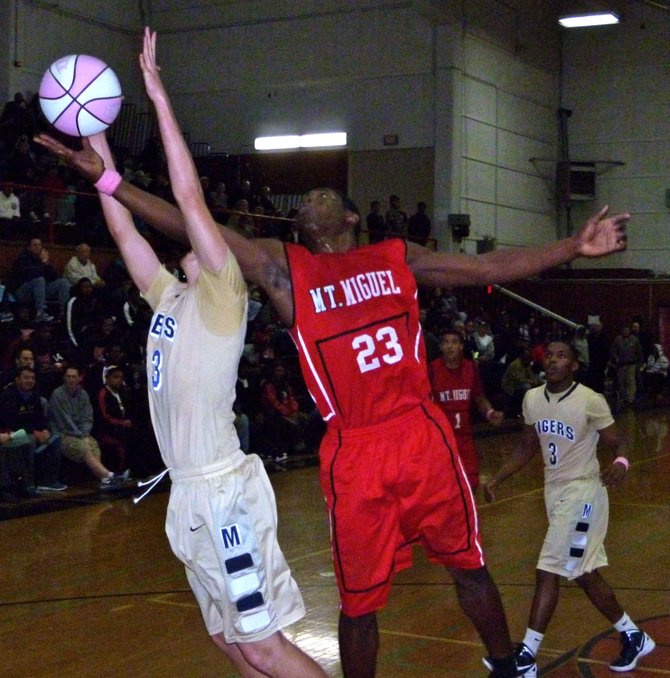 Mount Miguel forward Cory Littleton hauls in a rebound over Morse forward Corey Phillips