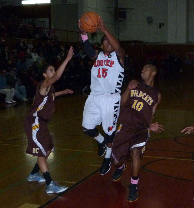 Hoover guard Chris Jones goes up to the basket between El Camino guards Tommy Griffin (15) and Dayton Boddie (10)