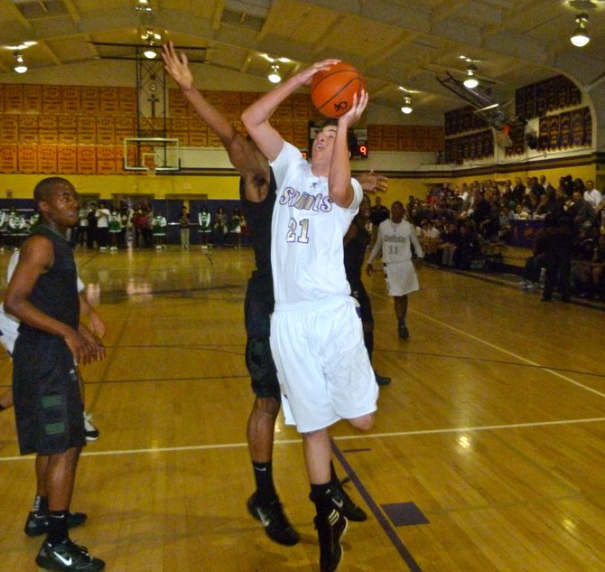 St. Augustine center Jack Drapp goes up for a shot in the lane