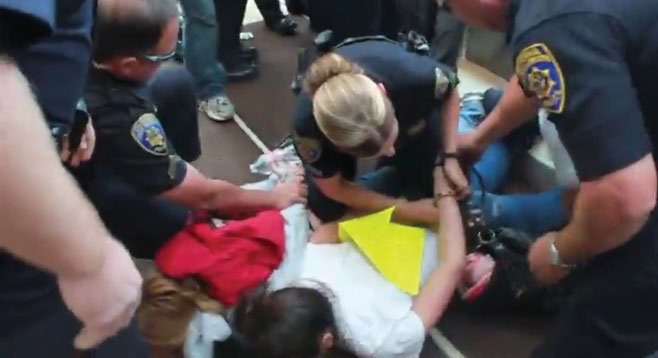 Ashley Wardle being handcuffed: “A cop grabbed me by my backpack and pulled me inside the building.”