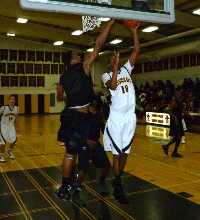 Mission Bay forward James Cloud goes up for a one-handed shot against Lincoln forward Jeremiah Turner