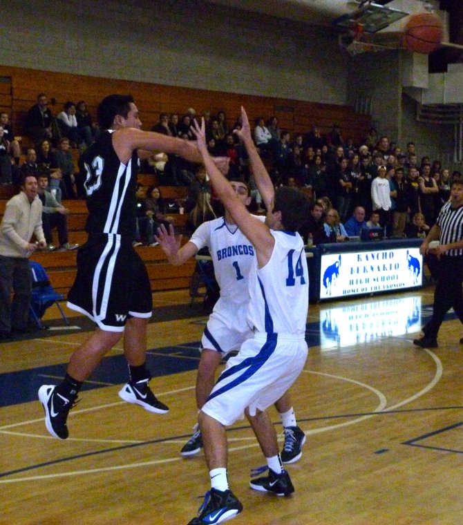 Westview guard Ryan Pineda fires a pass over the double team of Rancho Bernardo guard Sam Sanati (1) and forward Chase Little (14)